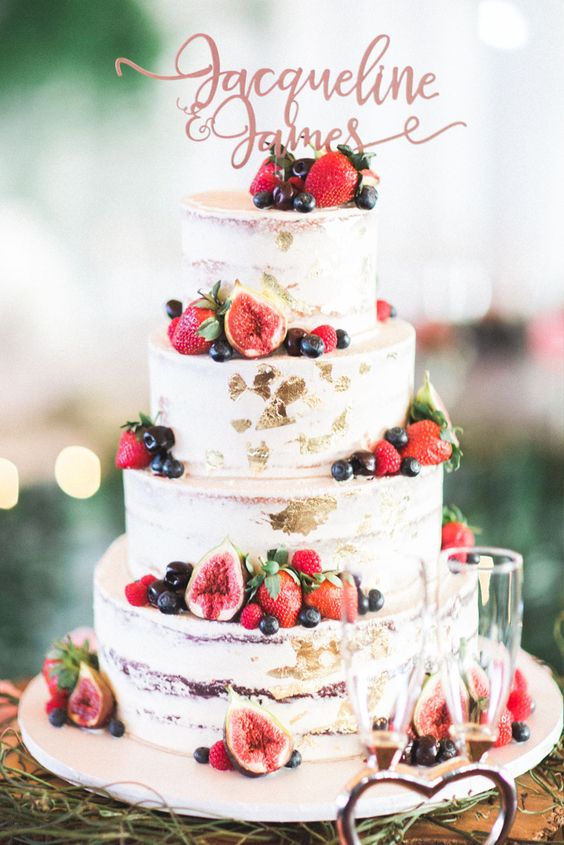 Semi naked wedding cake with gold foil and fresh berries by Two Peaches Photography